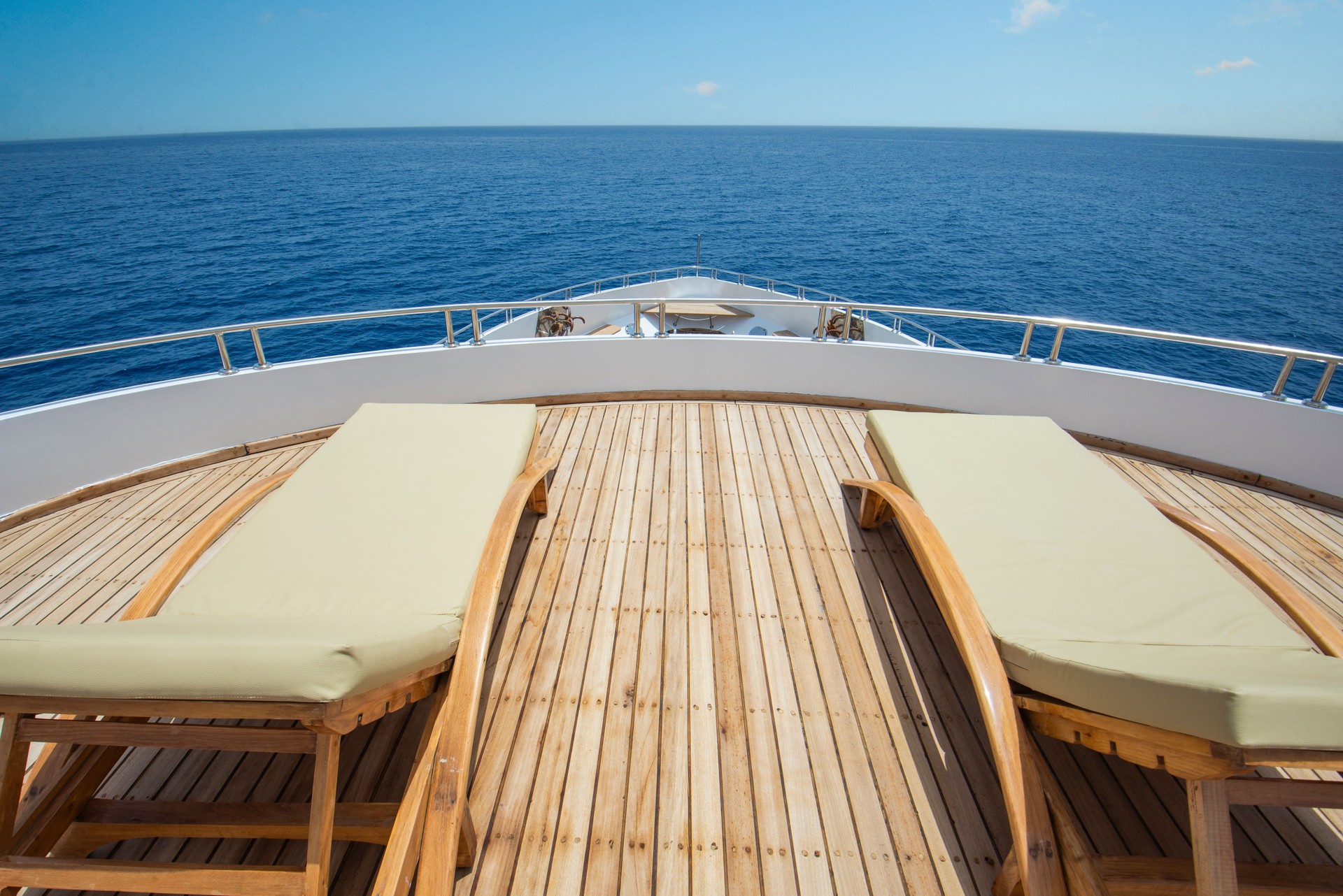 View from bow deck of luxury yacht with sunbeds